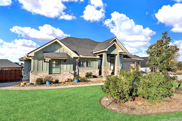 craftsman-style home featuring a garage and a front yard