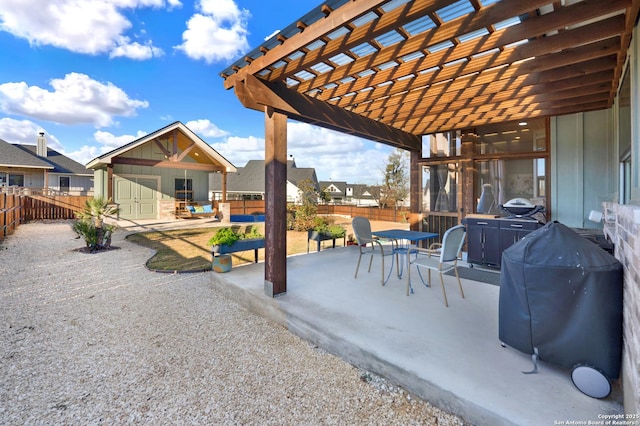 view of patio / terrace with grilling area, an outdoor structure, and a pergola