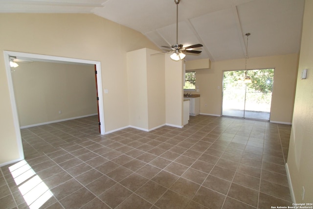 unfurnished living room featuring ceiling fan, vaulted ceiling, and a wealth of natural light