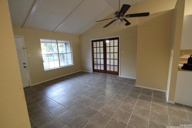 spare room with lofted ceiling, tile patterned floors, french doors, and ceiling fan