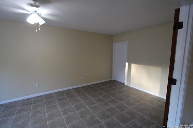 unfurnished room with dark tile patterned floors