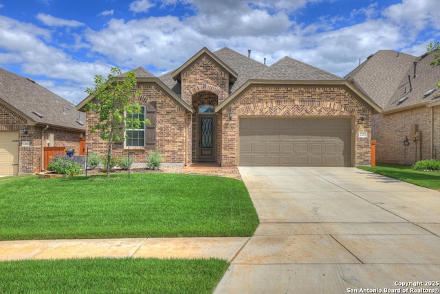 view of front of property featuring a garage and a front lawn