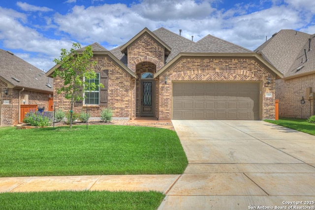 view of front of property with a garage and a front yard