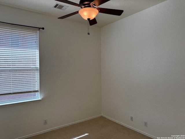 carpeted empty room with ceiling fan