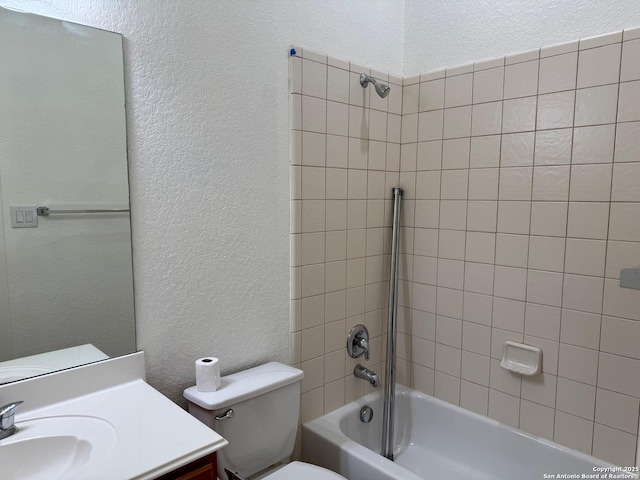 full bathroom with tiled shower / bath combo, vanity, and toilet