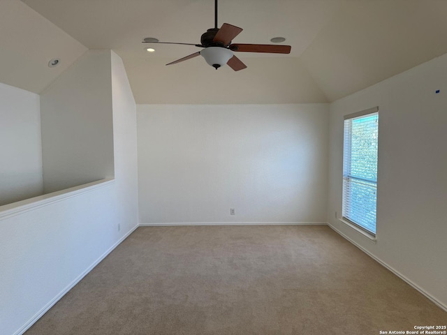 interior space featuring lofted ceiling, light carpet, and ceiling fan