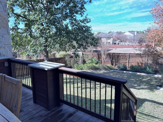 wooden deck featuring a yard