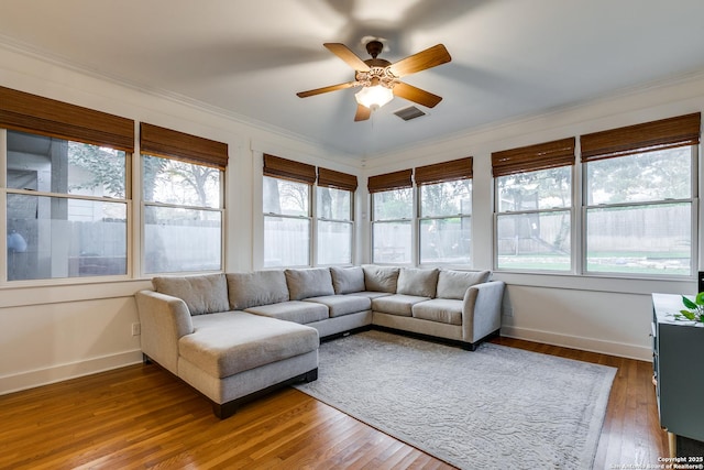 sunroom / solarium featuring ceiling fan