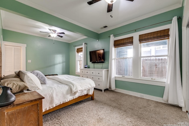 carpeted bedroom with crown molding and ceiling fan