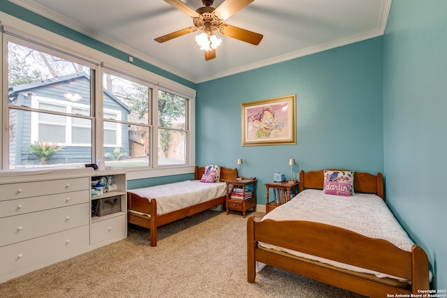 carpeted bedroom featuring ornamental molding and ceiling fan