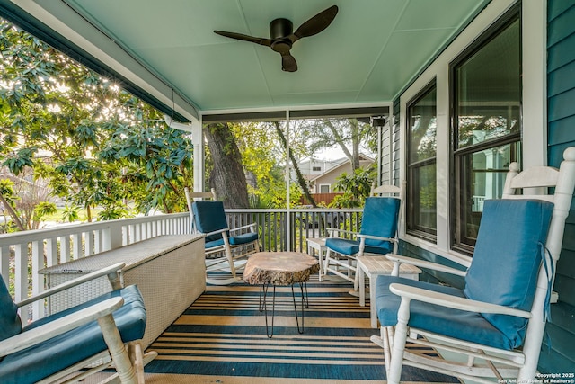 sunroom featuring ceiling fan