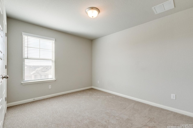 unfurnished room with light carpet