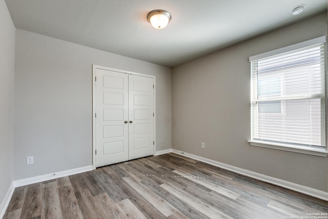 unfurnished bedroom with light hardwood / wood-style floors and a closet