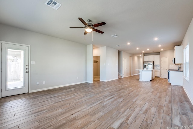 unfurnished living room with ceiling fan and light wood-type flooring