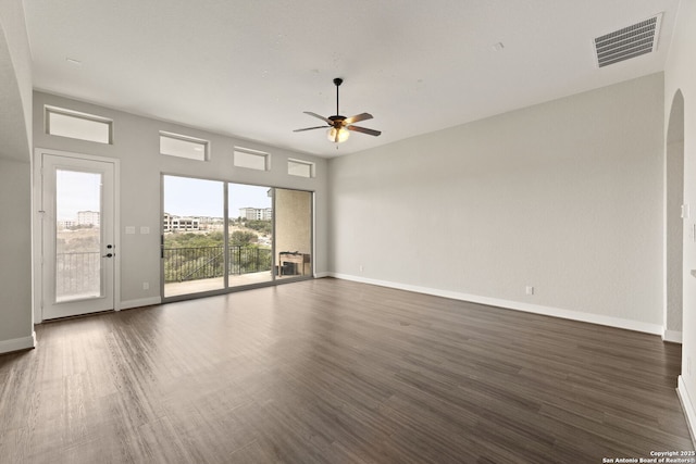 spare room featuring dark wood-type flooring and ceiling fan