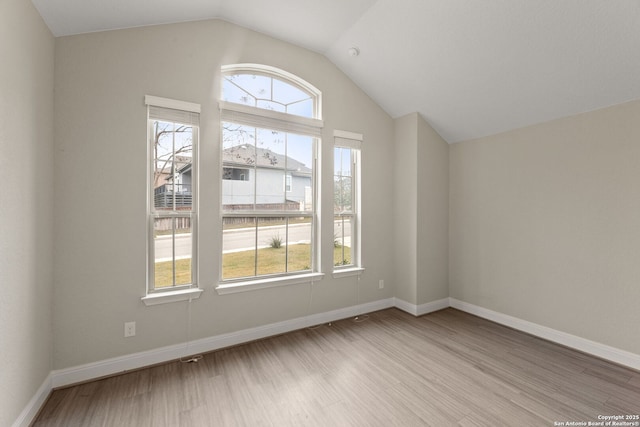 bonus room with lofted ceiling and light hardwood / wood-style floors