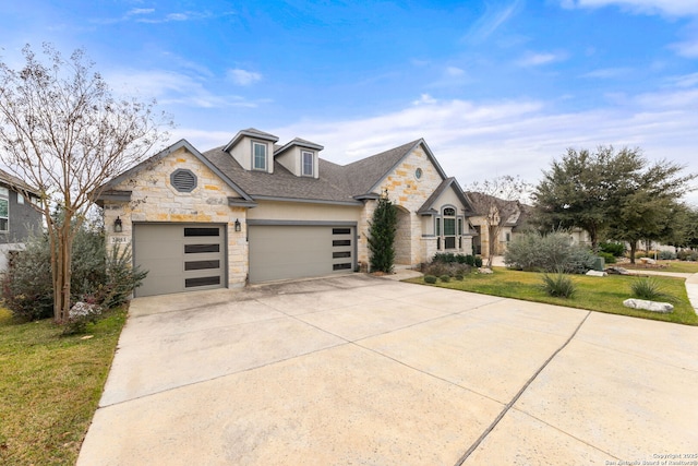 view of front of property featuring a garage and a front yard