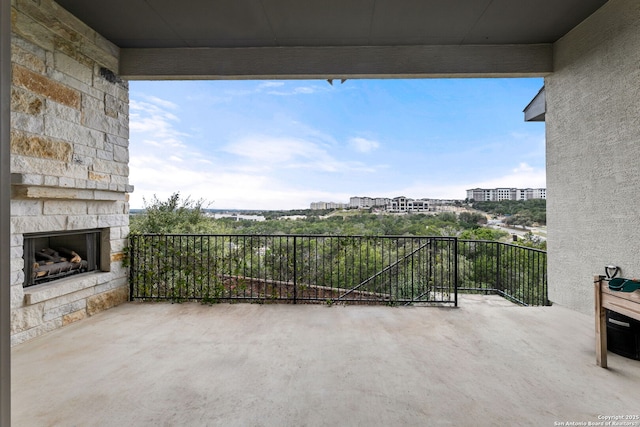 view of patio / terrace featuring an outdoor stone fireplace