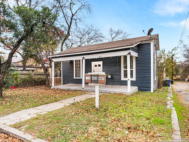 view of front of property with a front yard and covered porch