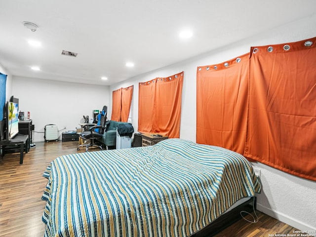 bedroom with hardwood / wood-style floors