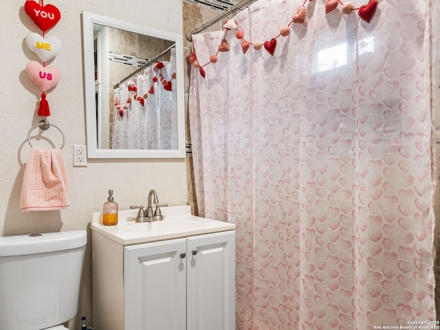 bathroom with vanity, walk in shower, and toilet