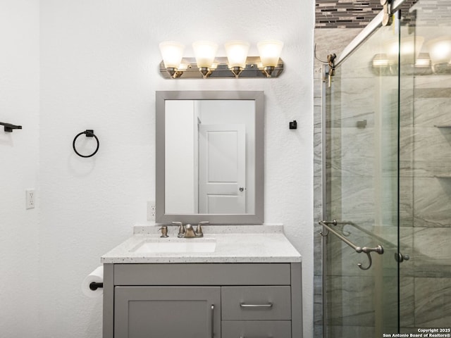 bathroom featuring vanity and an enclosed shower