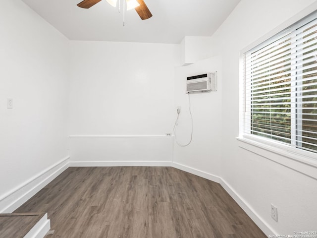 unfurnished room with ceiling fan, dark hardwood / wood-style flooring, and an AC wall unit