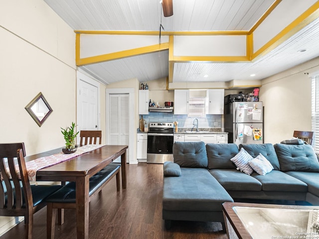 living room with sink, dark wood-type flooring, and vaulted ceiling