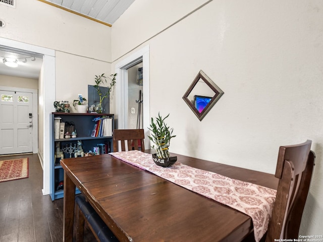 dining space featuring dark wood-type flooring