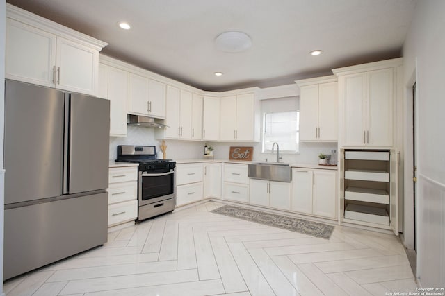 kitchen featuring white cabinetry, sink, stainless steel appliances, and light parquet flooring