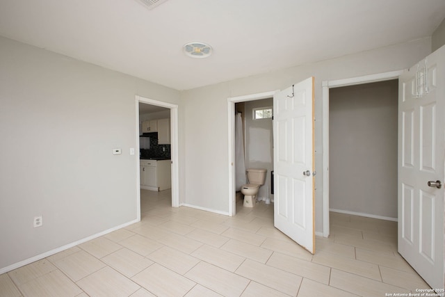 unfurnished bedroom featuring ensuite bathroom