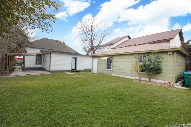 rear view of house featuring a yard and a patio