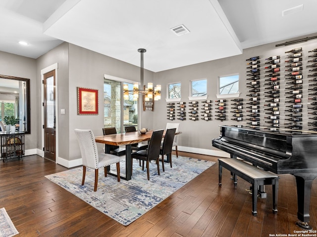 dining room featuring dark wood-type flooring and an inviting chandelier