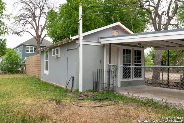 exterior space with a yard and a carport