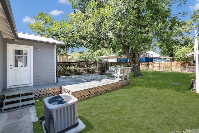 view of yard with a wooden deck and central AC