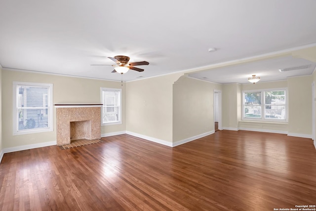 unfurnished living room featuring crown molding, wood-type flooring, ceiling fan, and a high end fireplace