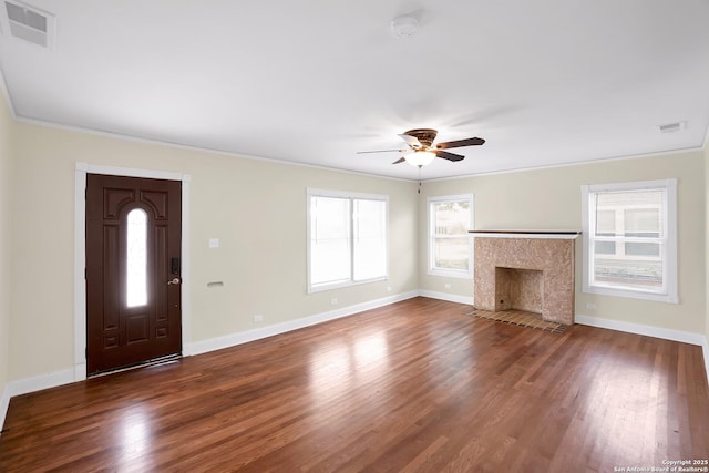 unfurnished living room with ceiling fan, ornamental molding, dark hardwood / wood-style flooring, and a high end fireplace