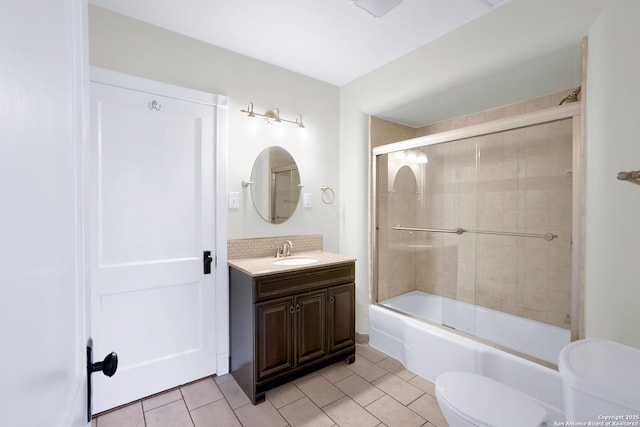 full bathroom with tile patterned floors, toilet, vanity, enclosed tub / shower combo, and backsplash