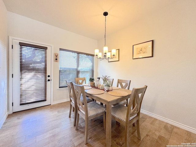 dining room with a notable chandelier and light hardwood / wood-style flooring