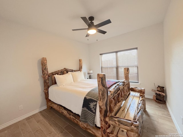 bedroom with ceiling fan and dark hardwood / wood-style flooring