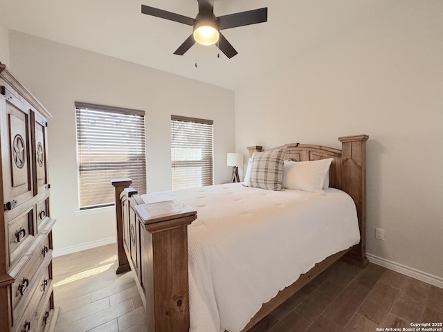 bedroom with dark hardwood / wood-style flooring and ceiling fan