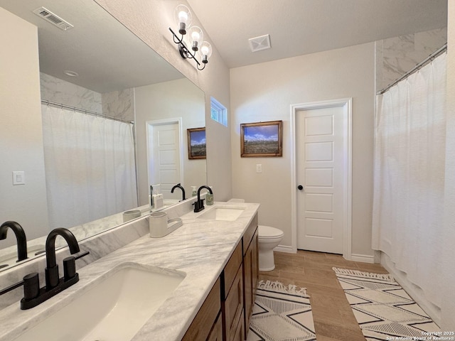 bathroom with a shower with curtain, vanity, and toilet