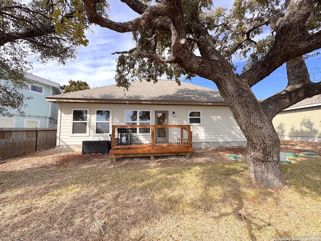 back of house with a wooden deck and a yard