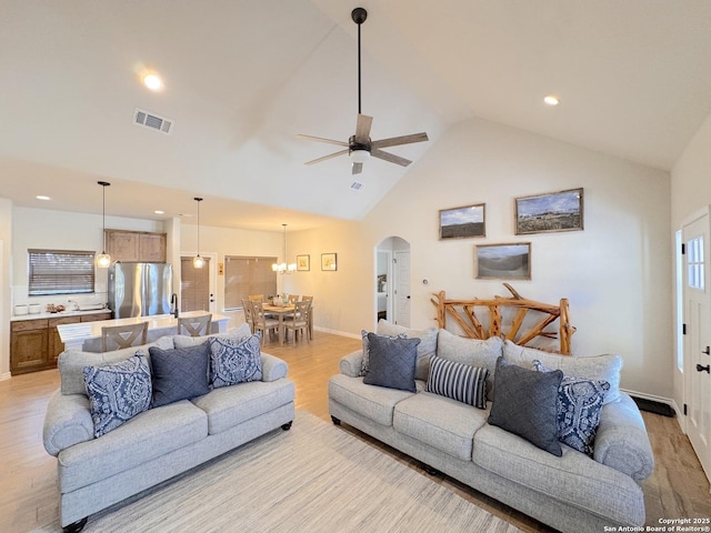 living room featuring ceiling fan, high vaulted ceiling, and light hardwood / wood-style floors