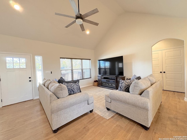 living room featuring high vaulted ceiling, ceiling fan, and light hardwood / wood-style flooring