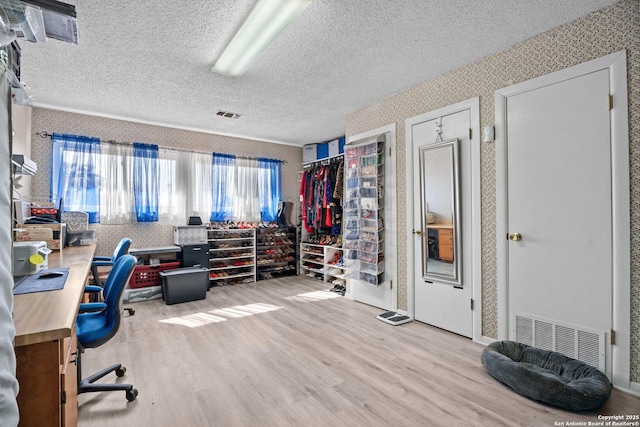 office featuring a textured ceiling and light wood-type flooring