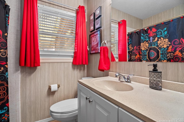 bathroom featuring vanity, toilet, and a textured ceiling