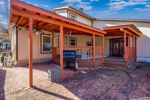 exterior space with a patio area, french doors, and ceiling fan