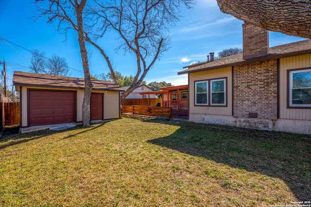 view of yard featuring a garage and an outdoor structure