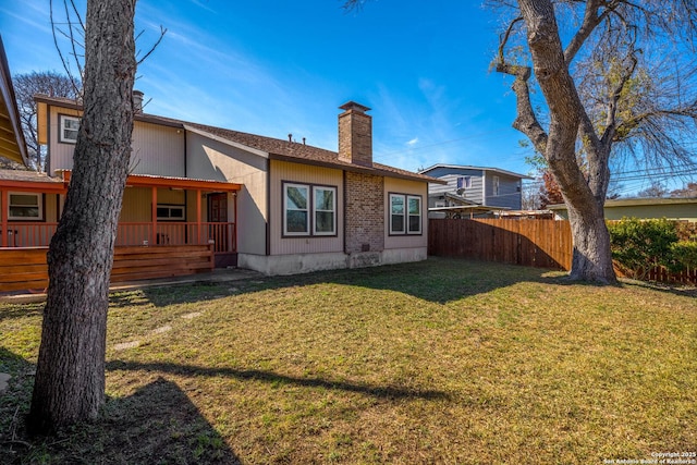 rear view of property featuring a yard